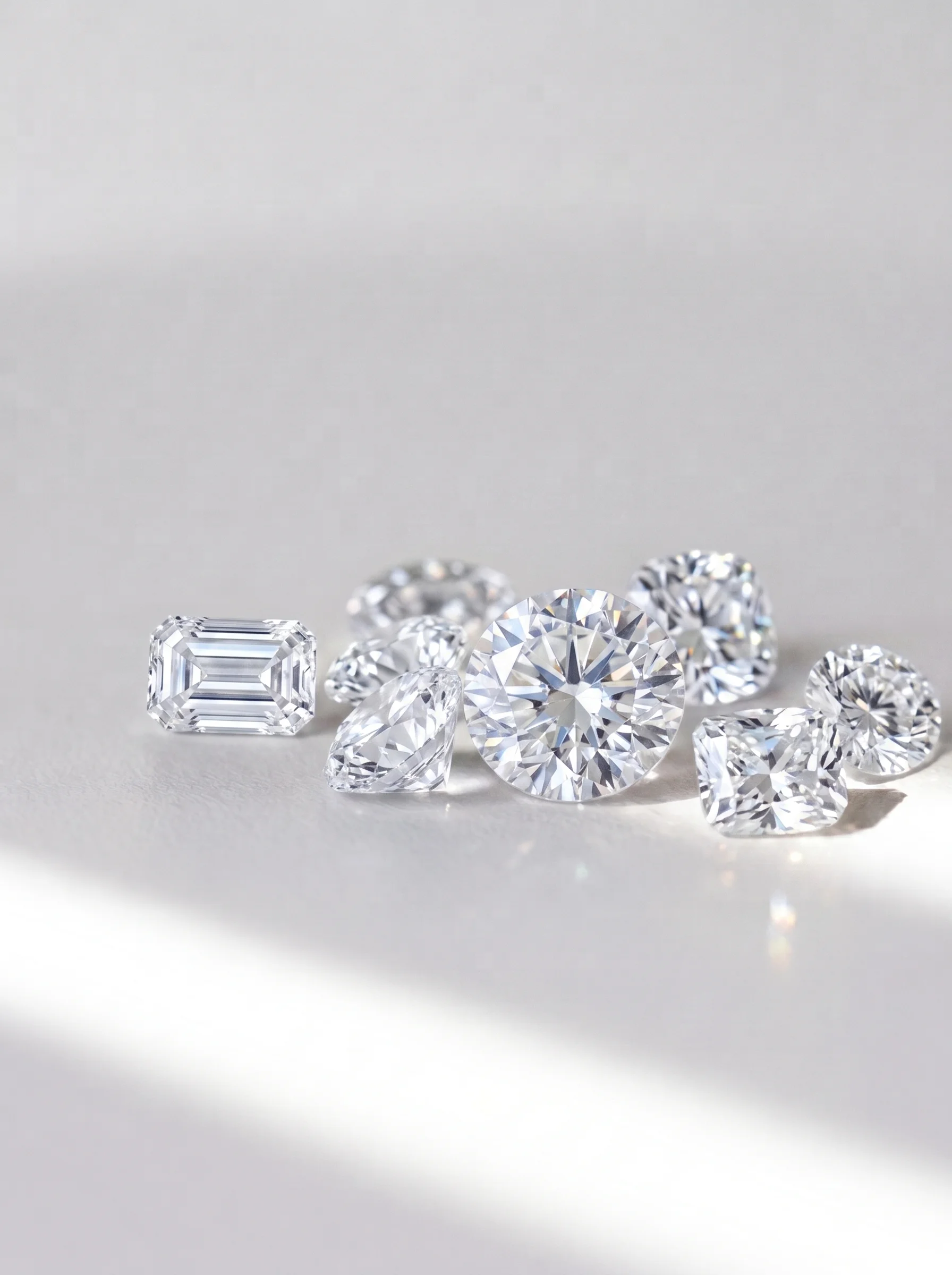 Loose diamonds arranged on a light surface