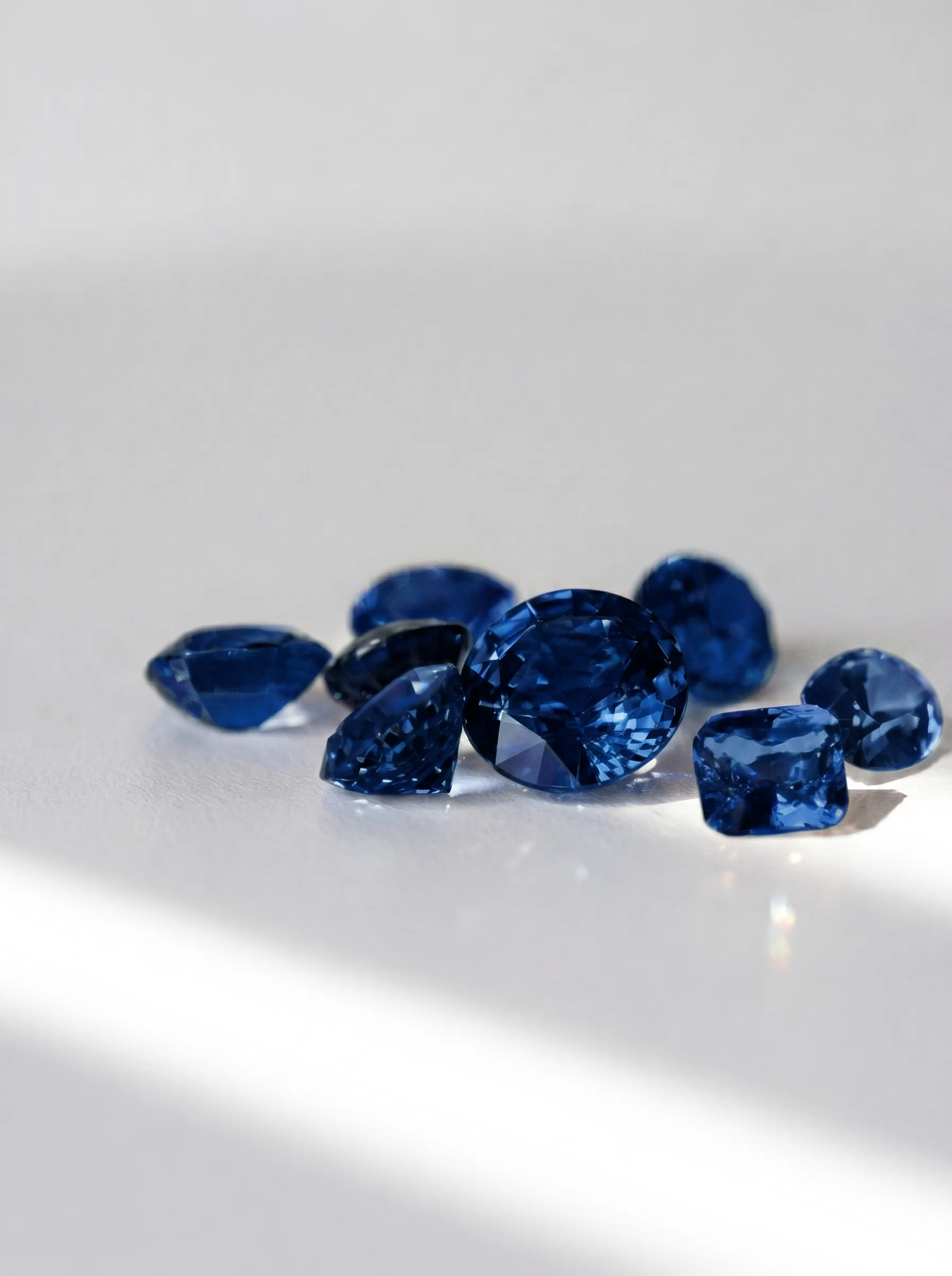 Loose sapphires arranged on a light surface